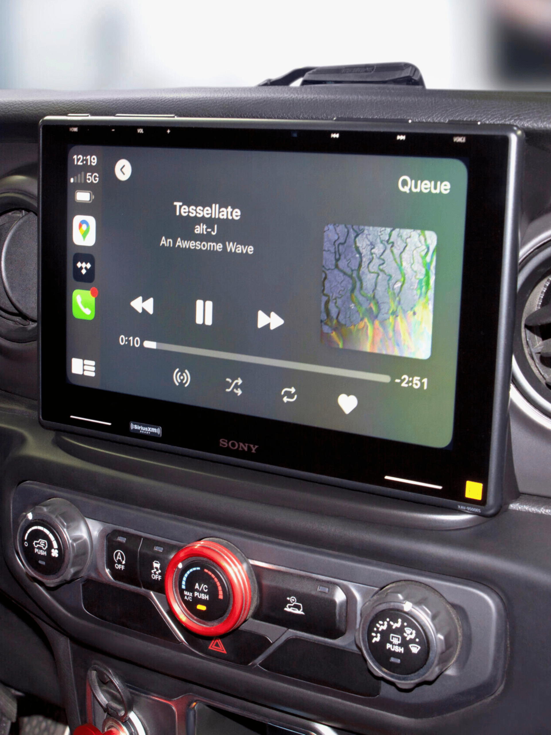 Sony car infotainment system showing music playback interface with album art and controls.